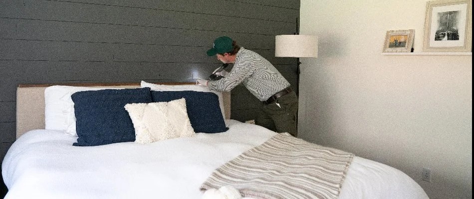 Worker inspecting the back of a bed in Sumner, WA, for bed bugs. 